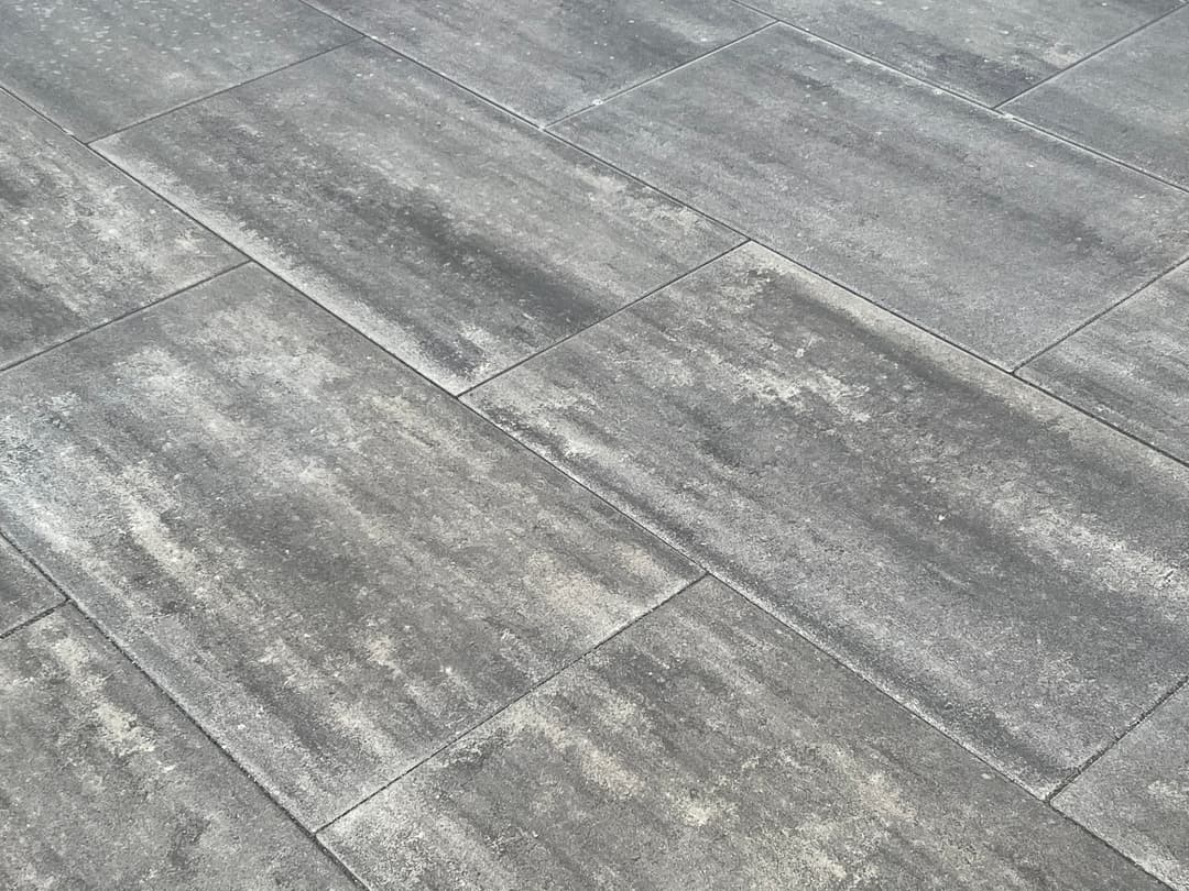 Gray textured floor tiles with a modern design and subtle variations in color.