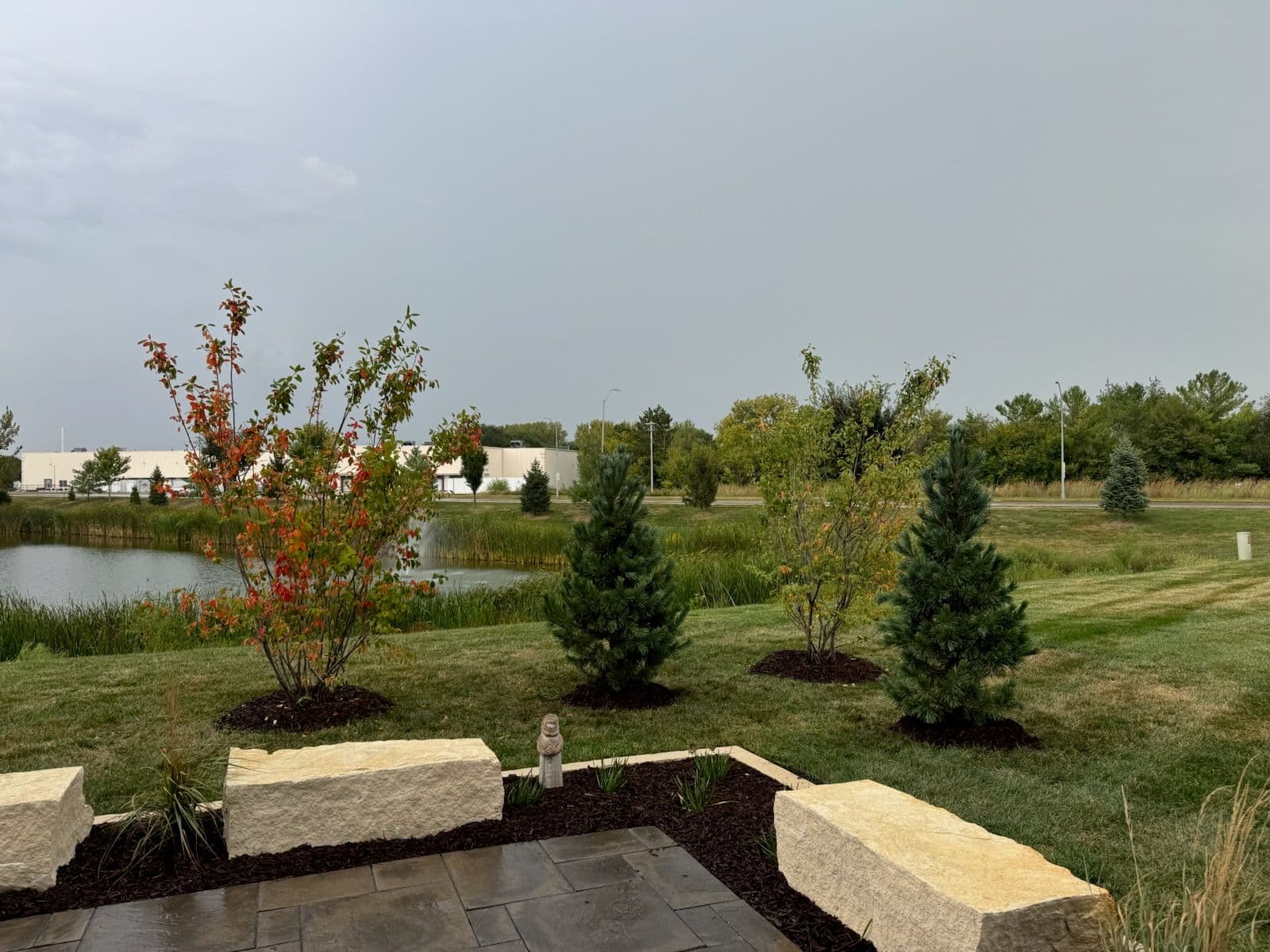 Creating a Peaceful Outdoor Retreat with Stone Patio and Plantings image